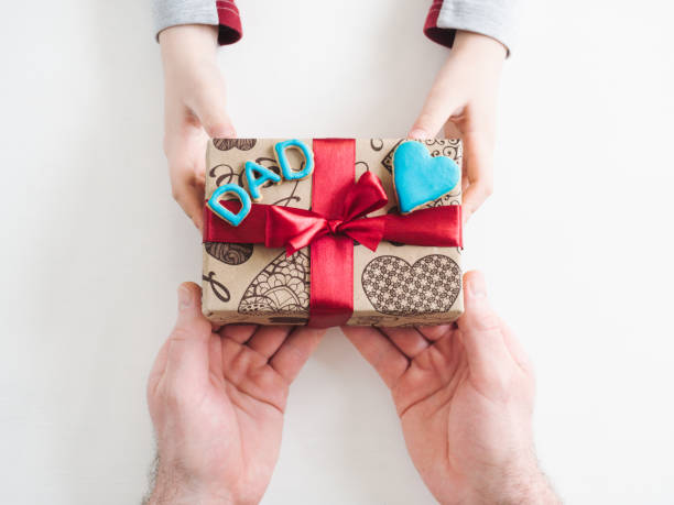 istock Child's hands and a beautiful gift box 1144200274