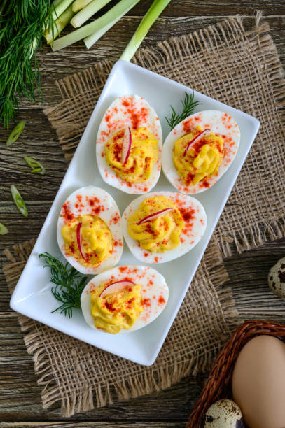 istock Deviled eggs. Delicious appetizer. Boiled eggs stuffed with yolk, mustard, mayonnaise, paprika. Classic recipe. The top view 1144200795