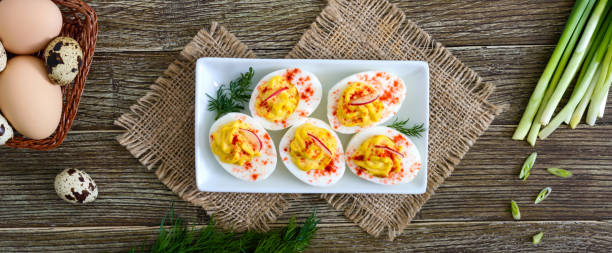 istock Deviled eggs. Delicious appetizer. Boiled eggs stuffed with yolk, mustard, mayonnaise, paprika. Classic recipe. The top view. Banner 1144200802