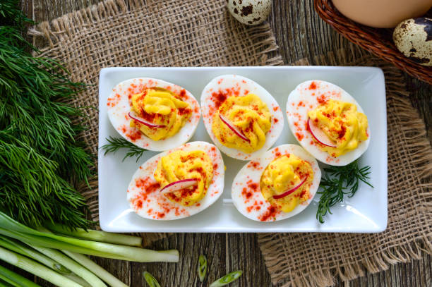 istock Deviled eggs. Delicious appetizer. Boiled eggs stuffed with yolk, mustard, mayonnaise, paprika. Classic recipe. The top view 1144200803