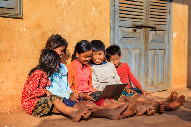 istock Happy Cambodian children using laptop on a schoolyard, Cambodia 1144200818