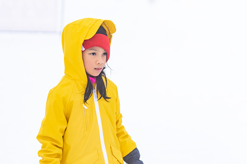 Portrait of Asian kid gril in yellow winter clothing