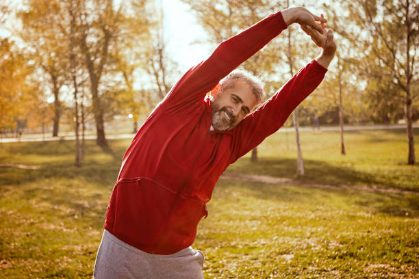istock Senior man stretching in park 1144201205