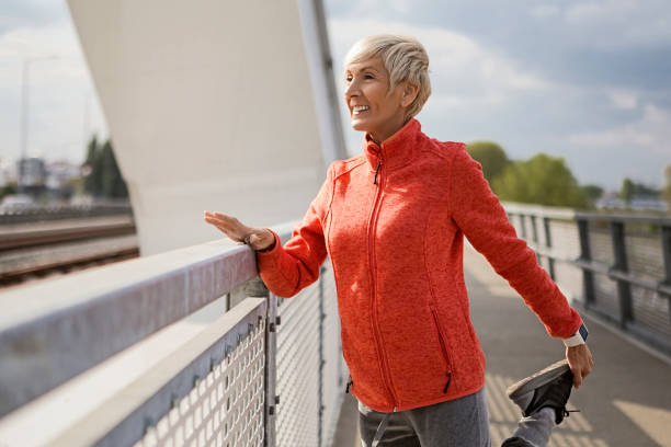 istock Smiling senior woman stretching 1144201387