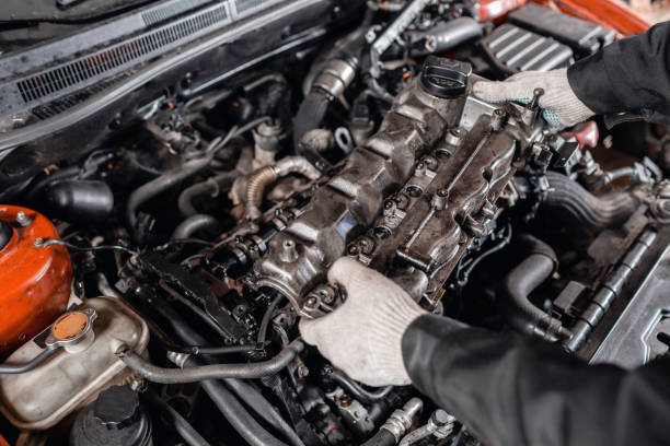 istock Mechanic take to pieces engine head. Repairing of modern diesel engine, workers hands and tool. 1144202422