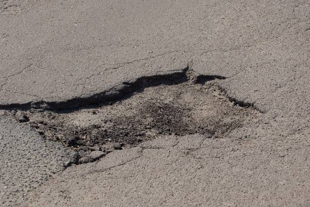 istock big pothole on the gray asphalt road 1144202545