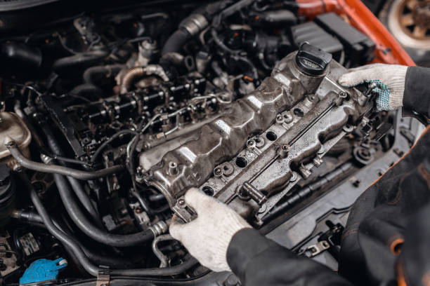 istock Mechanic take to pieces engine head. Repairing of modern diesel engine, workers hands and tool. 1144202761