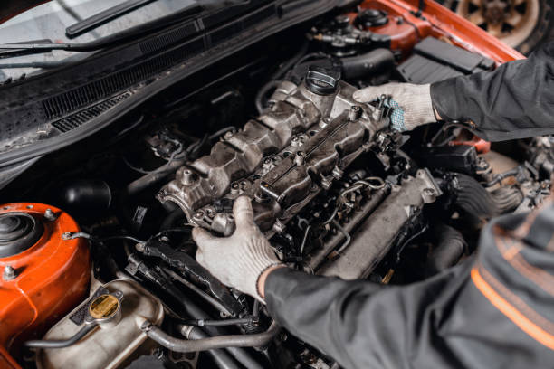 istock Mechanic take to pieces engine head. Repairing of modern diesel engine, workers hands and tool. 1144203592
