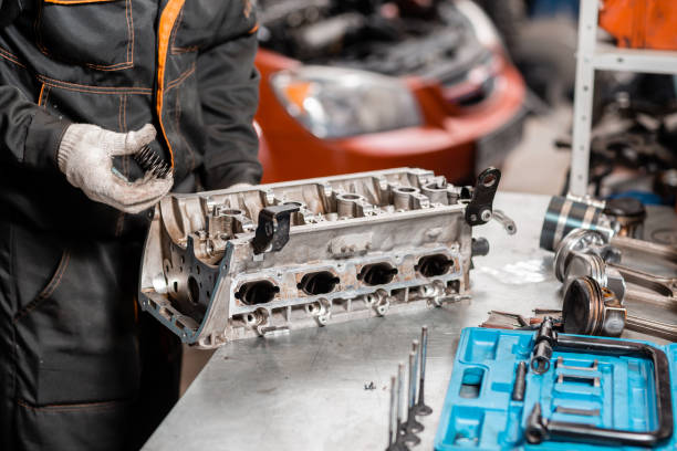 istock Mechanic disassembling the engine, overhaul.. Engine on a repair stand with piston and connecting rod of automotive technology. Interior of a car repair shop. 1144203631