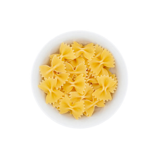 istock Pile of farfalle paste in a white bowl isolated 1144203649