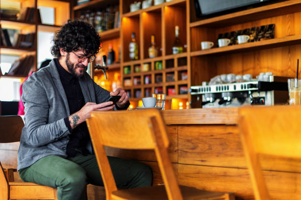 istock Man sitting in the coffee shop and using smart phone 1144205461