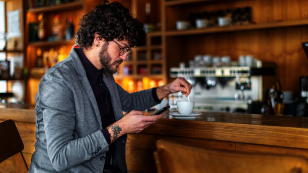 istock Man sitting in the coffee shop and using smart phone 1144205545