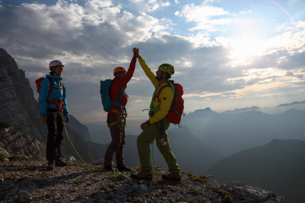 istock Three mountaineers celebrating on the top 1144205627