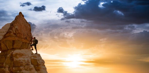 silhouette of successful climbing woman in mountains Concept of concept of motion motivation inspiration at beautiful sunset