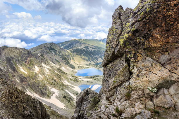 istock Two mountain lakes and foreground rock with flowers on Rila mountain 1144208247