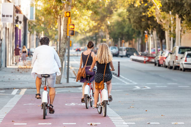 29 JULY 2018, BARCELONA, SPAIN: Cyclists crossing road intersection. Bicycle as urban transport