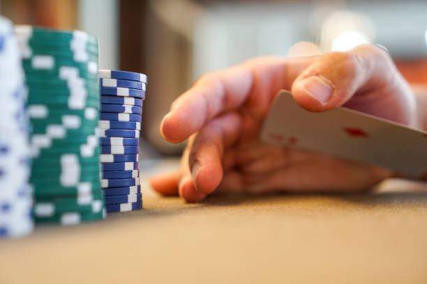 istock secretly palming a playing card at poker table with poker chips 1144209750