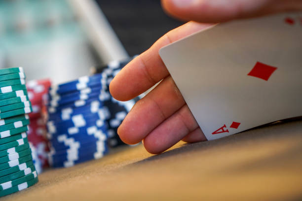 secretly palming a playing card at poker table with poker chips
