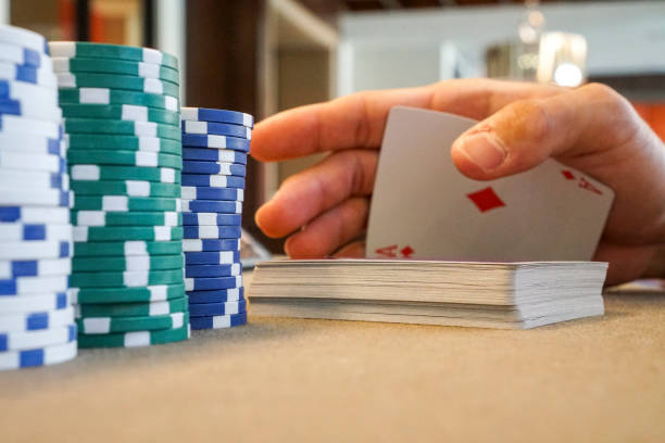 istock secretly palming a playing card at poker table with poker chips 1144209799