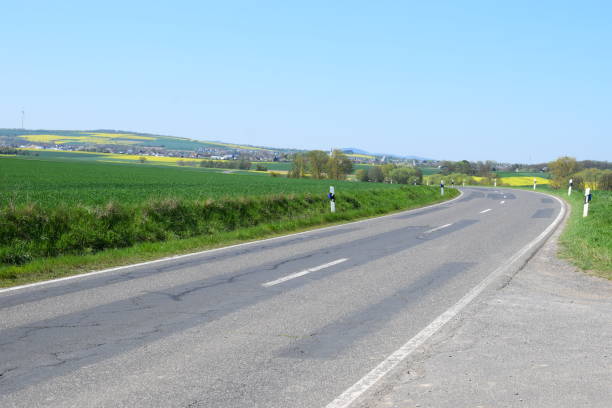 istock country road through green and yellow fields in spring 1144211031