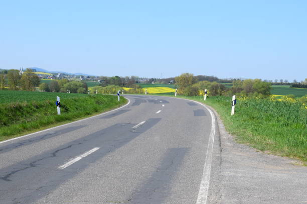 istock country road through green and yellow fields in spring 1144211048