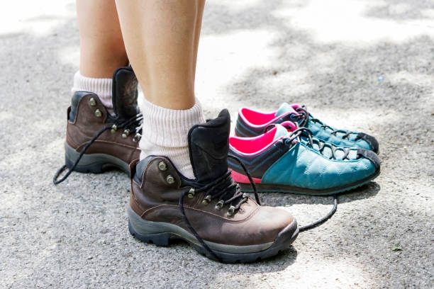 istock Female hiker tying hiking shoe 1144211758