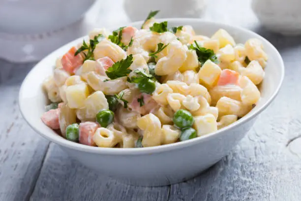 Homemade macaroni salad with elbow pasta, vegetables and mayonnaise dressing