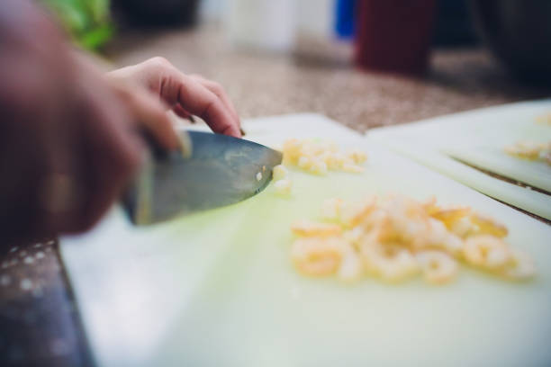 istock Grilled prawns with knife on white chopping board for cooking. 1144216324