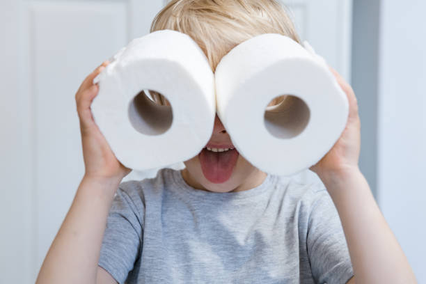 Boy looking into improvised binoculars Little boy looking into two rolls of toilet paper paper towel photos stock pictures, royalty-free photos & images