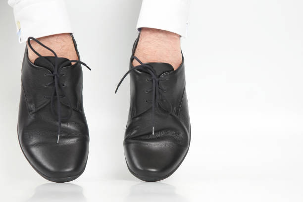 istock Classic shoes worn on the hands on a white background 1144217267