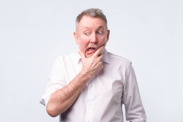 istock Sad senior man in white shirt thinking abour life. 1144218208