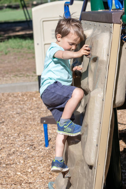 istock Little boy climbing in a playground 1144218288