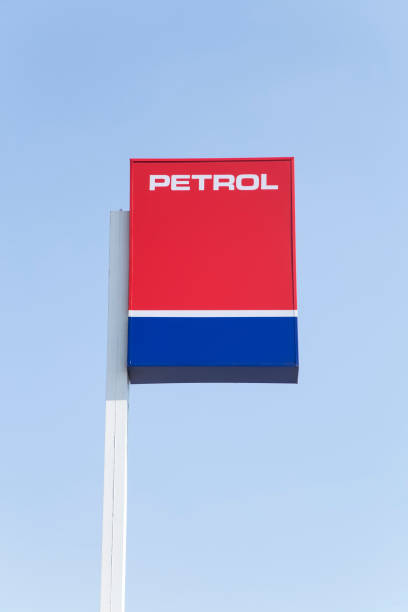 Metal petrol sign over blue sky