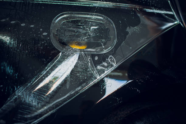 istock Worker hands installs car paint protection film wrap. 1144222967