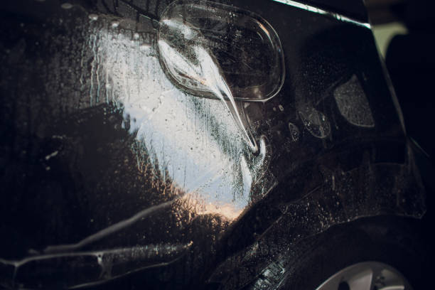 istock Worker hands installs car paint protection film wrap. 1144222982