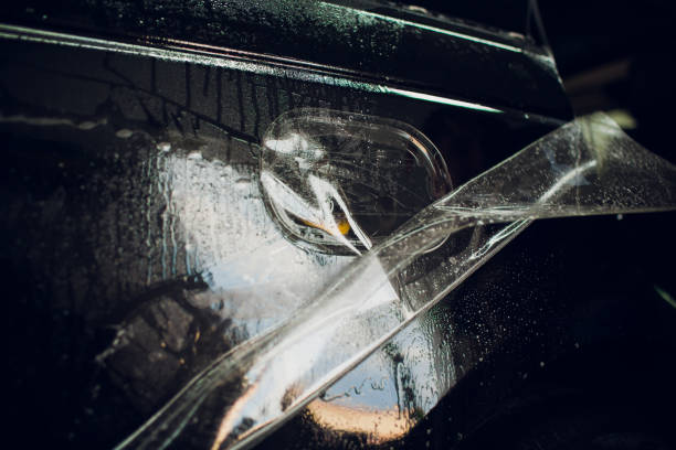 istock Worker hands installs car paint protection film wrap. 1144222986