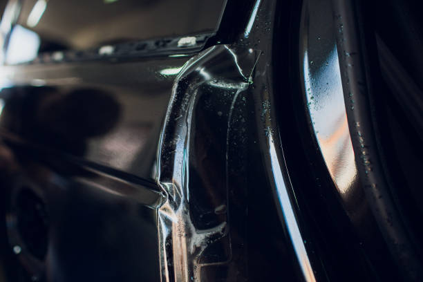 istock Worker hands installs car paint protection film wrap. 1144222992