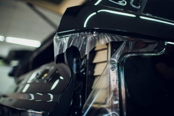 istock Worker hands installs car paint protection film wrap. 1144223004