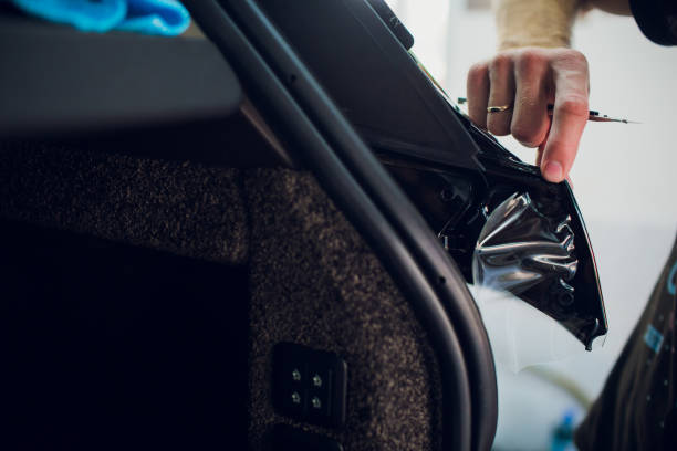 istock Worker hands installs car paint protection film wrap. 1144224263