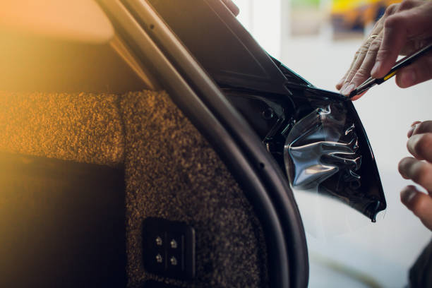 istock Worker hands installs car paint protection film wrap. 1144224269