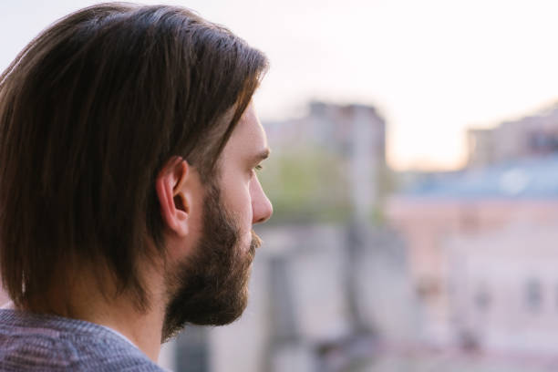 istock Mid adult man standing at terrace side view 1144224989