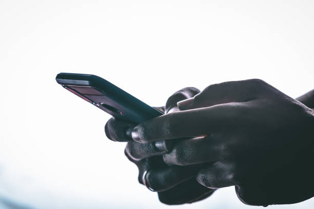istock hands holding and texting in a smartphone 1144225863