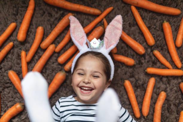 istock Cute and joyful bunny-eared girl playing on a easter day 1144226153