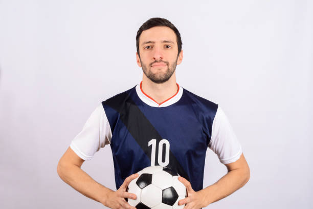istock Man with football ball. 1144227819