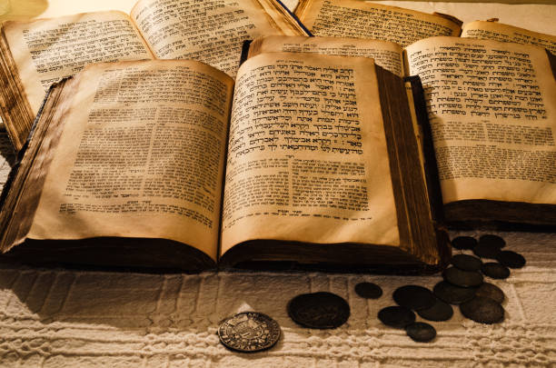 Livros judaicos antigos sagrados Pilha de livros antigos abertos em hebraico e moedas antigas espalhadas sobre a mesa. Toalha de mesa de linho talmud fotos de stock, fotos e imagens livres de direitos