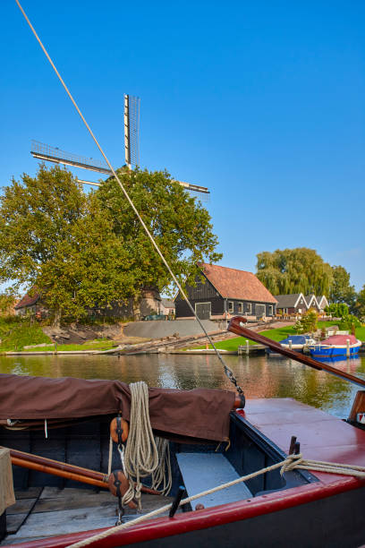 istock Tjalk sailing barge in Amsterdam with windmill. 1144230255