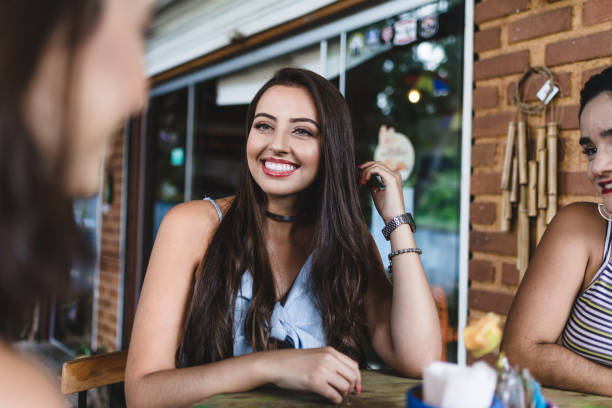 istock Young women gathered at a cafeteria table 1144233756