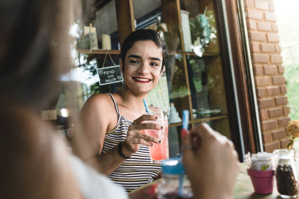 istock Beautiful young woman inside juice house 1144233796
