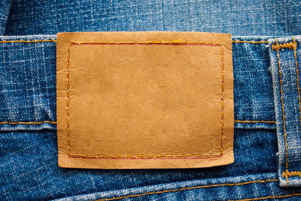 istock Blue denim jeans leather label texture background 1144235338