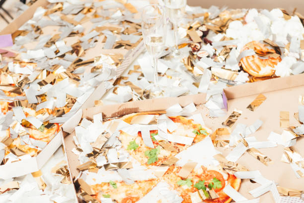 istock party mess pizza champagne leftover confetti 1144235394
